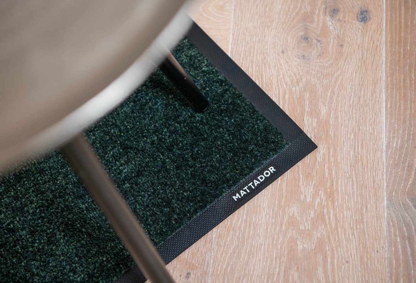 Groene binnenmat Mattador Mariner onder stoel met logo
